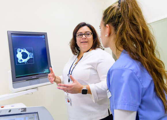 A professor of diagnostic imaging and program director of radiologic sciences, examines remains with students.
